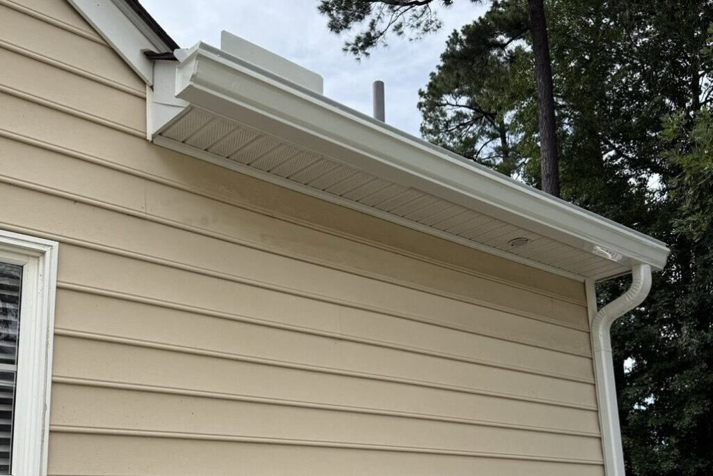 New seamless gutter and downspout installed by Commonwealth Construction & Remodeling along vinyl siding