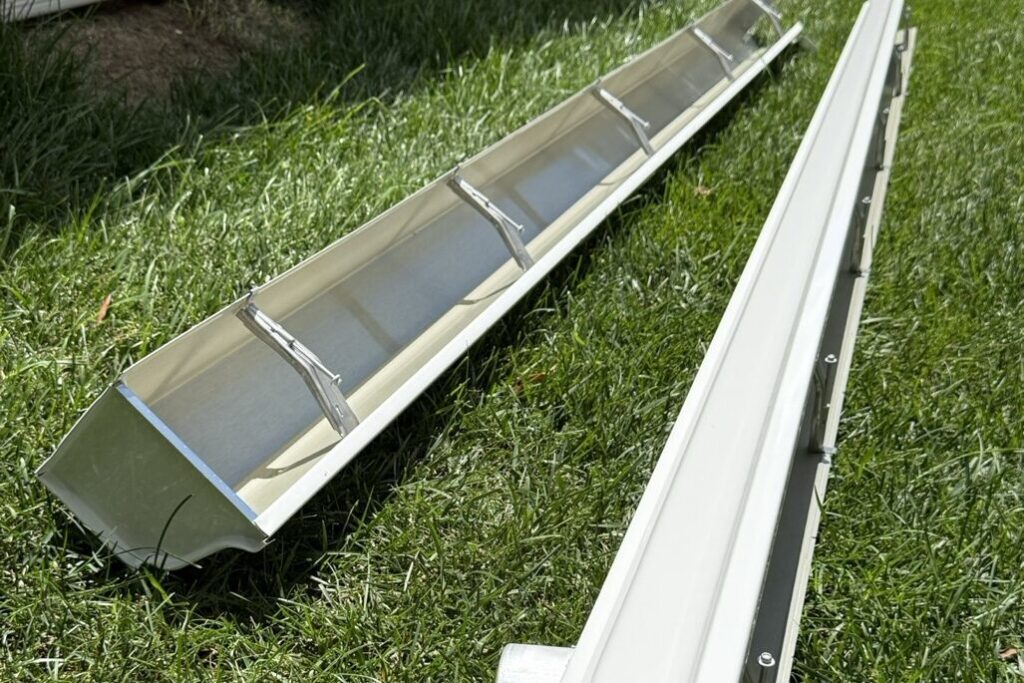 Seamless aluminum gutter sections with end caps ready for installation